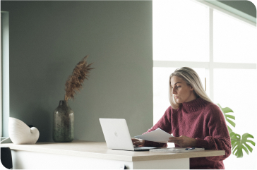 Woman using laptop at a desk.